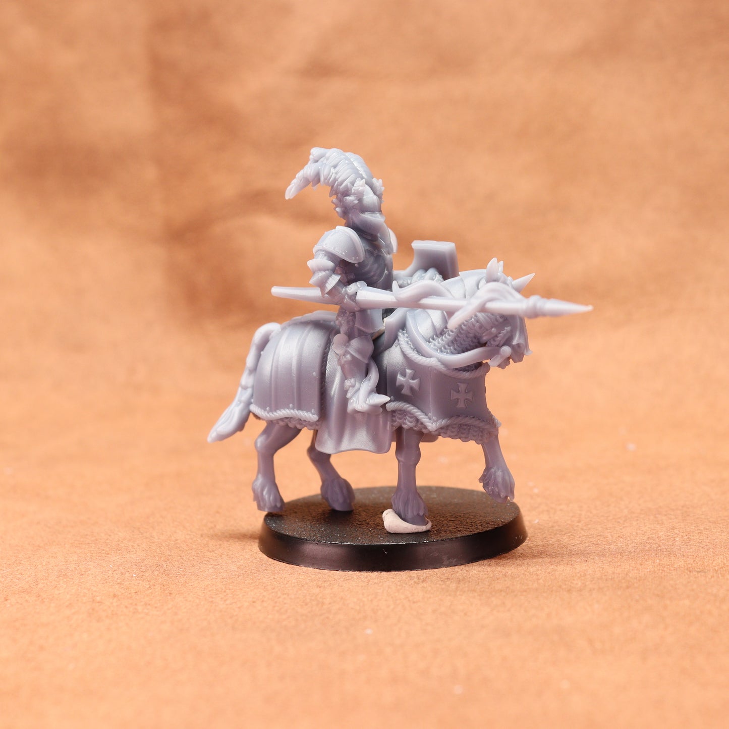 Minature figure of a warrior on horseback with armor and spear on a brown background