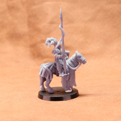 Gray figurine of a warrior on horseback with a spear on an orange background