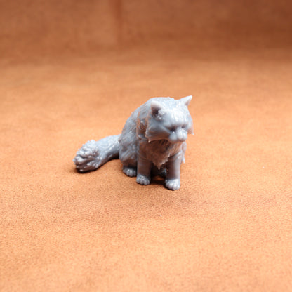 White cat figurine on a brown surface