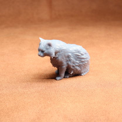 Gray cat figurine on a brown surface