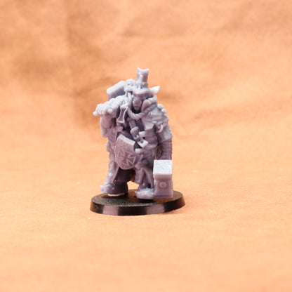 Gray miniature figure on a black base against an orange background