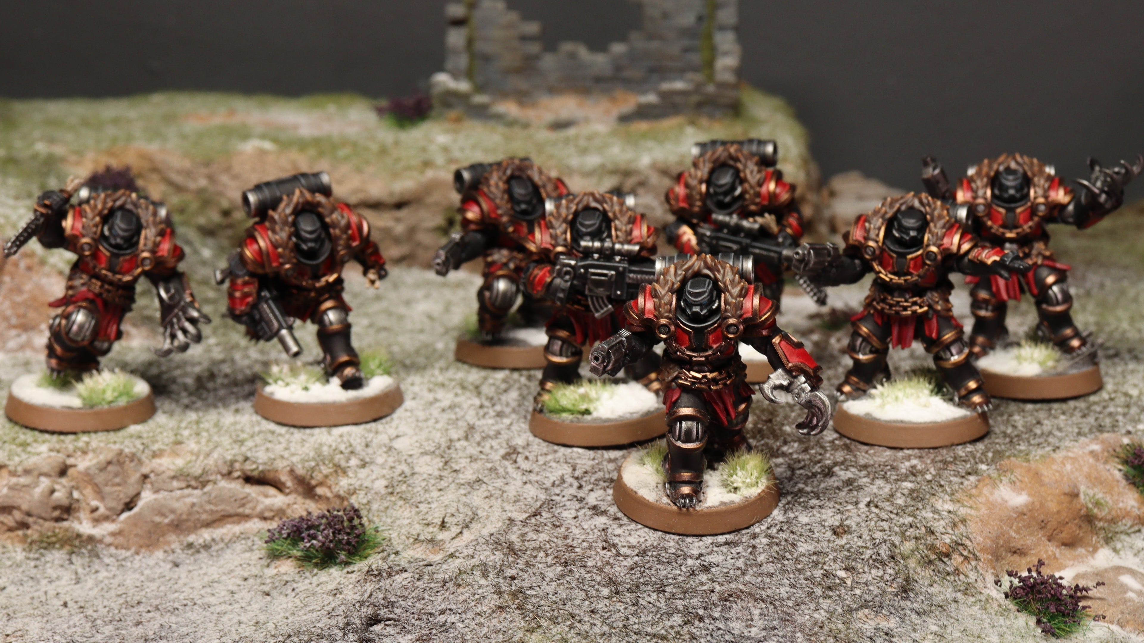Collection of miniature figures in a diorama setting with a dark background