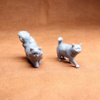 Two small white animal figurines on a brown surface