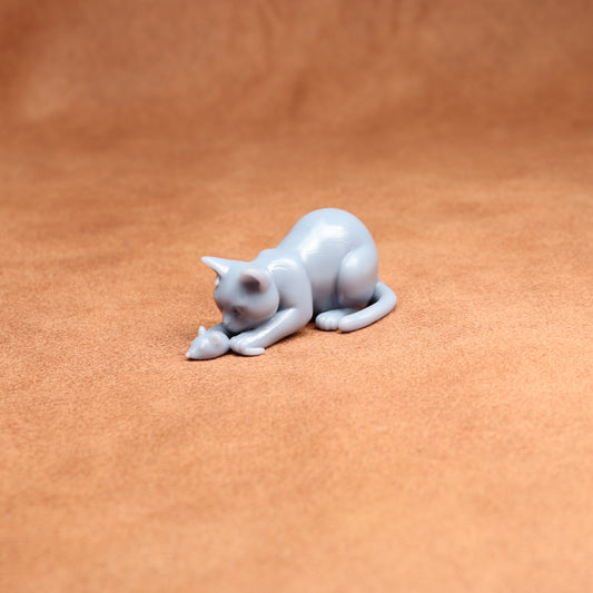 White cat figurine on a brown surface