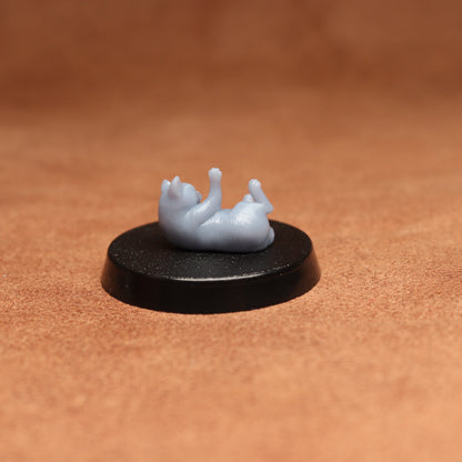 Small figurine on a black base against a brown background