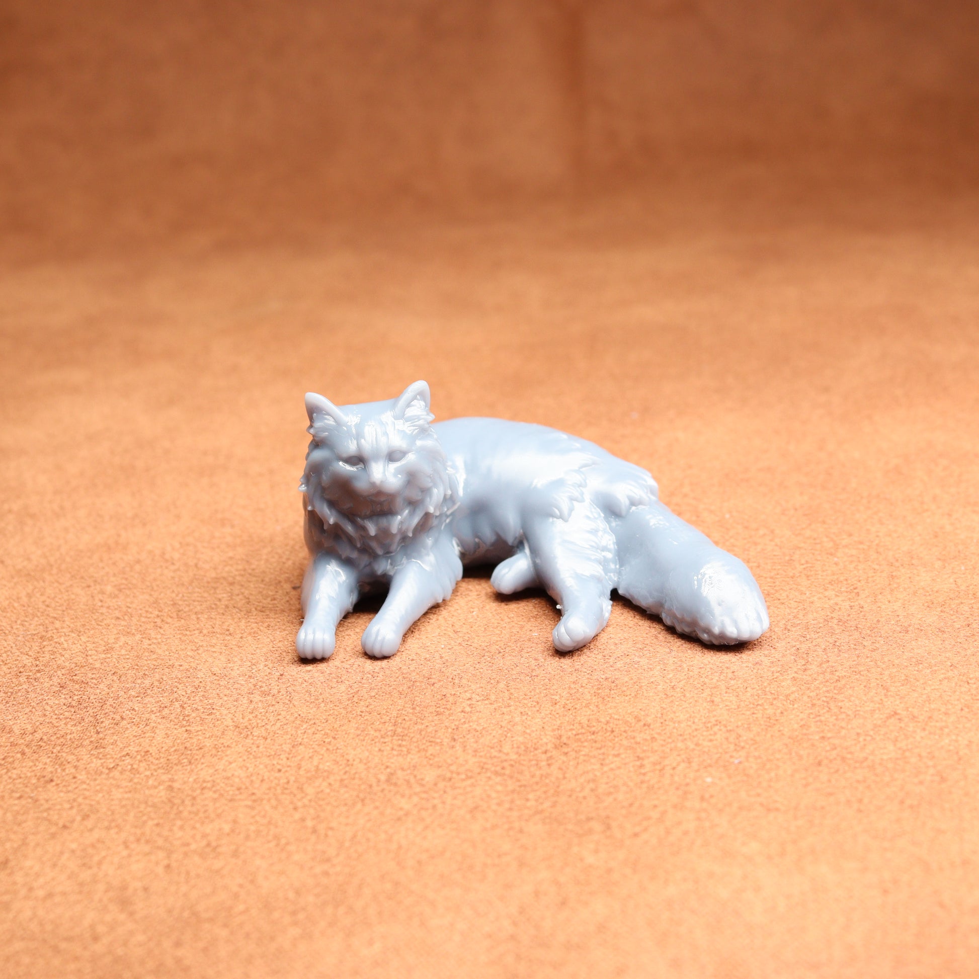 White cat figurine on a brown surface