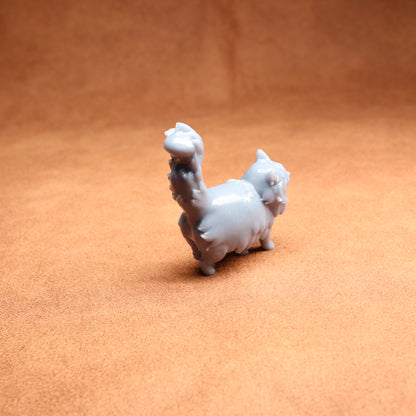 White ceramic llama figurine on a brown surface