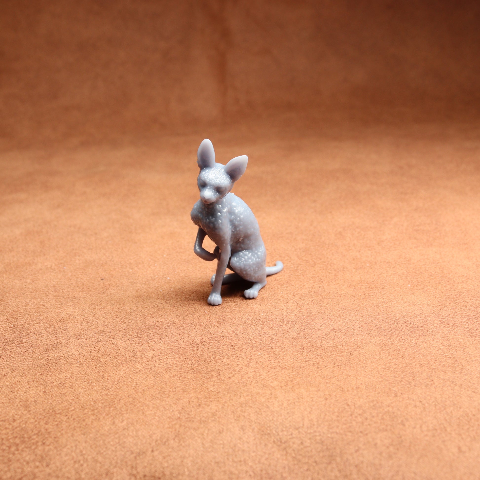 Gray dog figurine on a brown surface