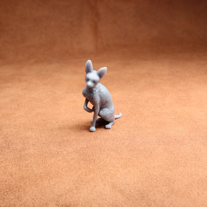Gray dog figurine on a brown surface