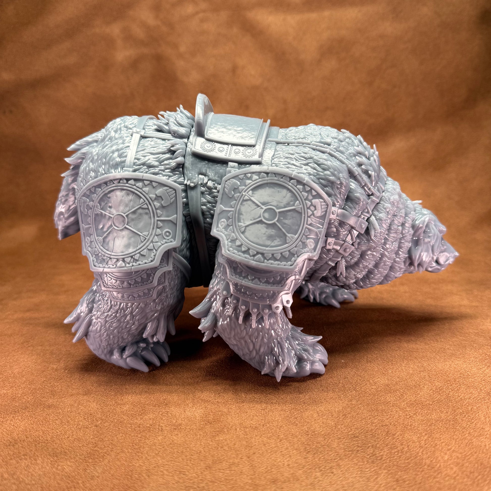 Toy figure of a bear with armor on a brown background