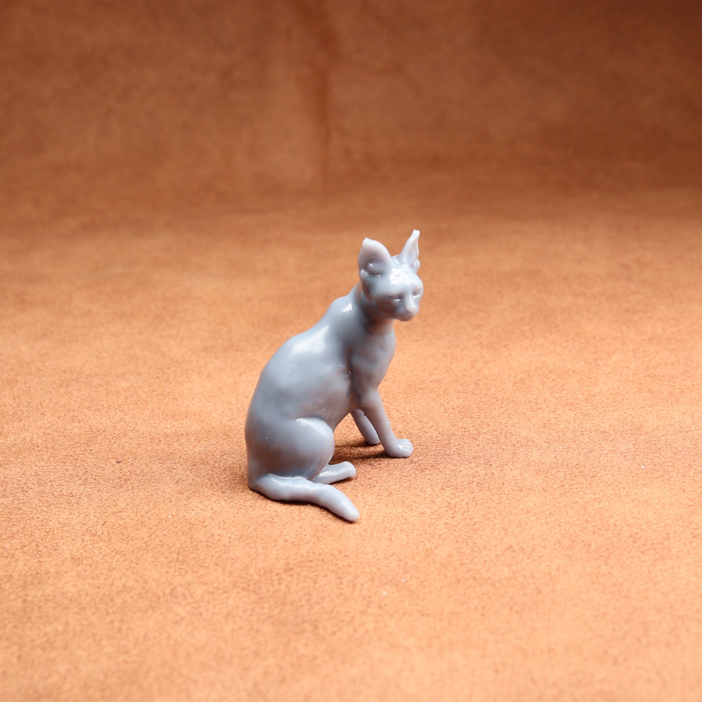 White cat figurine on a brown surface