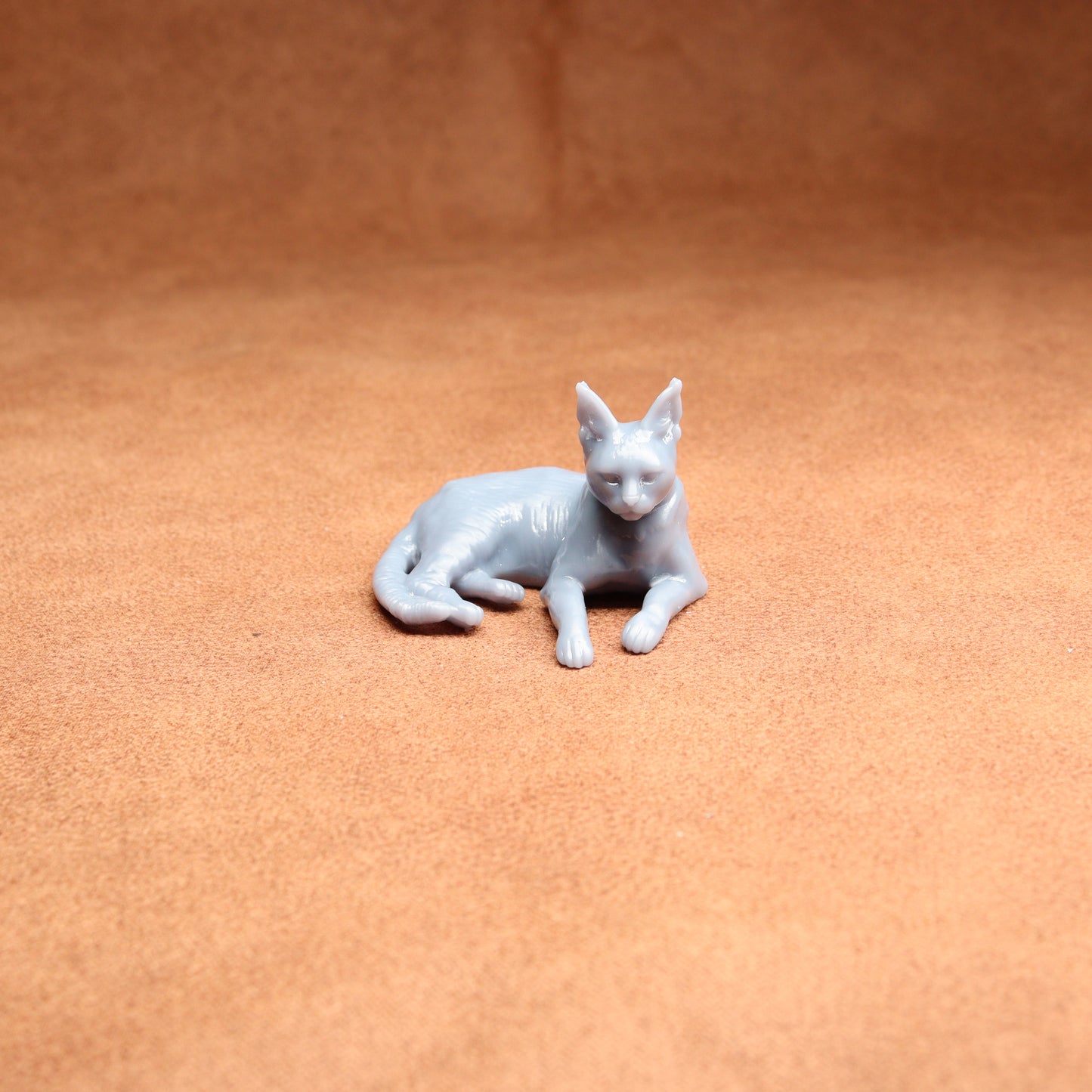 White cat figurine on a brown surface