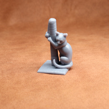 Gray cat figurine climbing a scratching post on an orange background