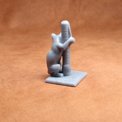 Gray 3D-printed figurine of a cat climbing a scratching post on an orange background
