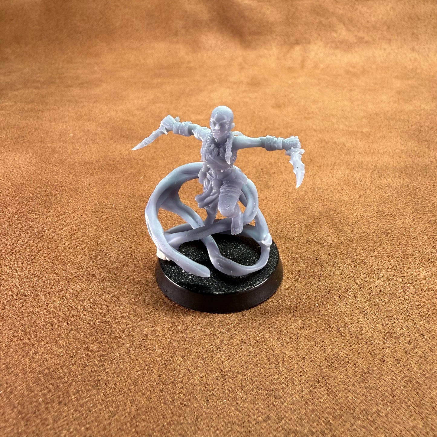 Gray fantasy figurine on a brown surface