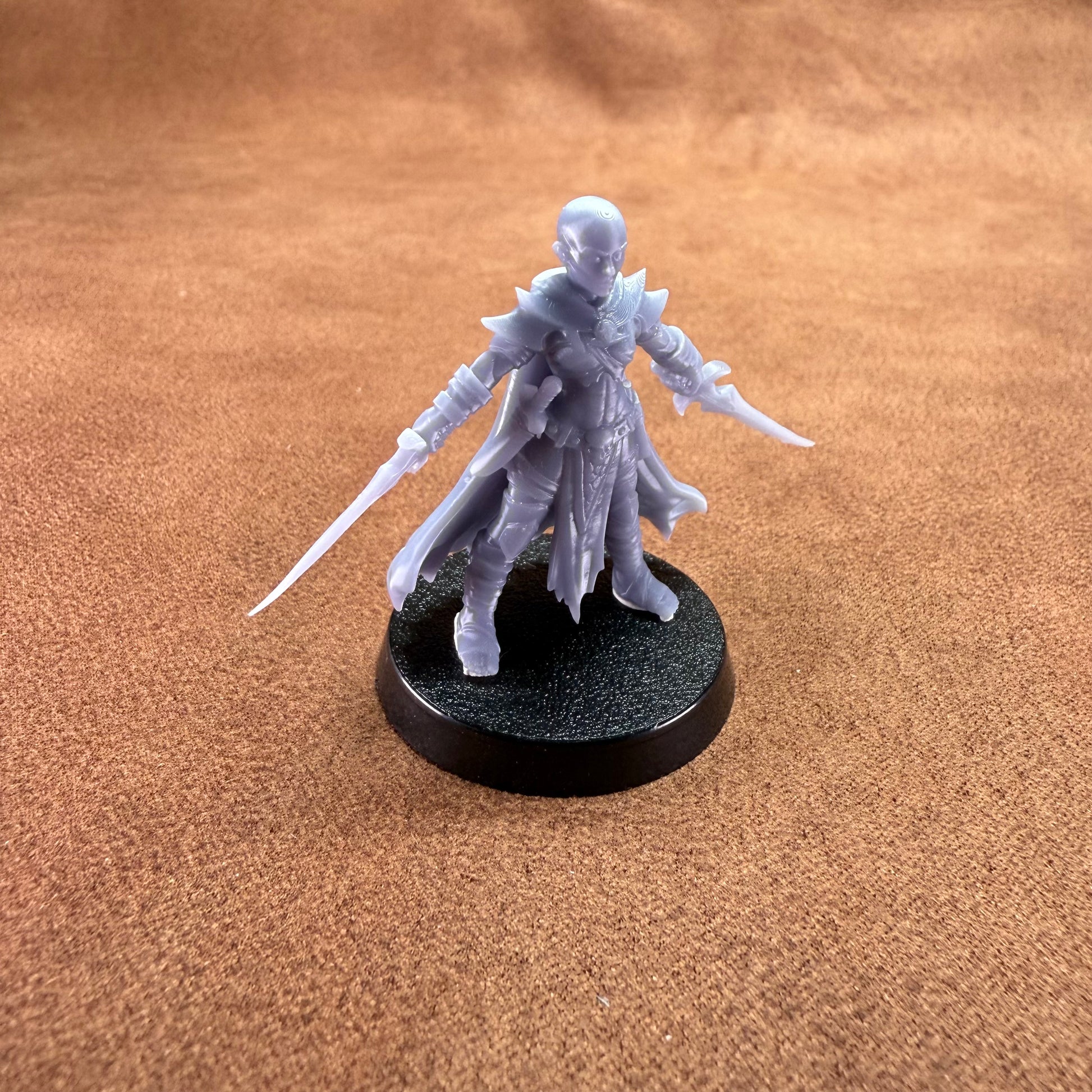 White fantasy figurine on a black base against a brown background
