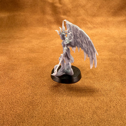 Fantasy figurine with wings on a brown surface