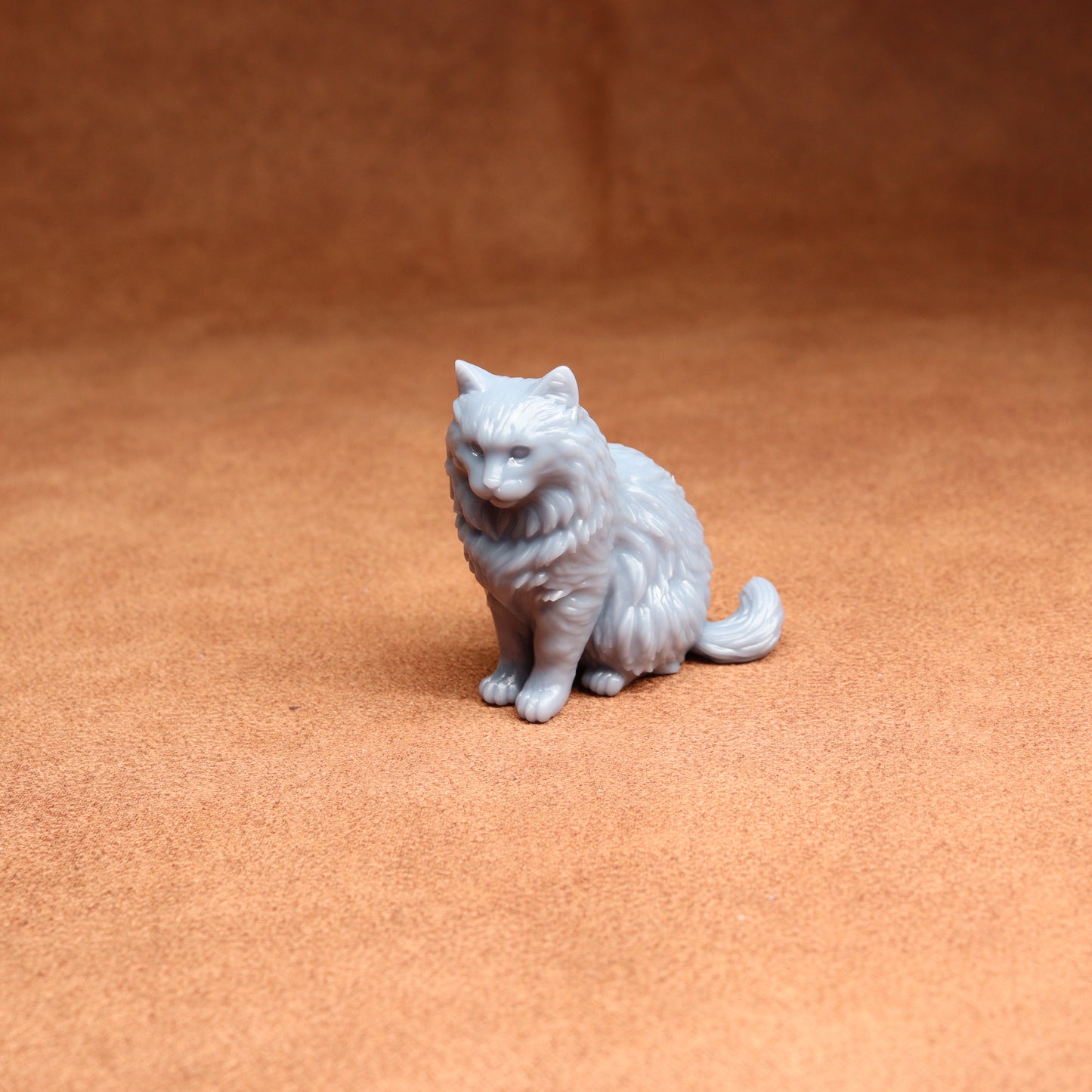 White cat figurine on a brown surface