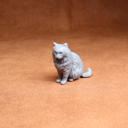 White cat figurine on a brown surface