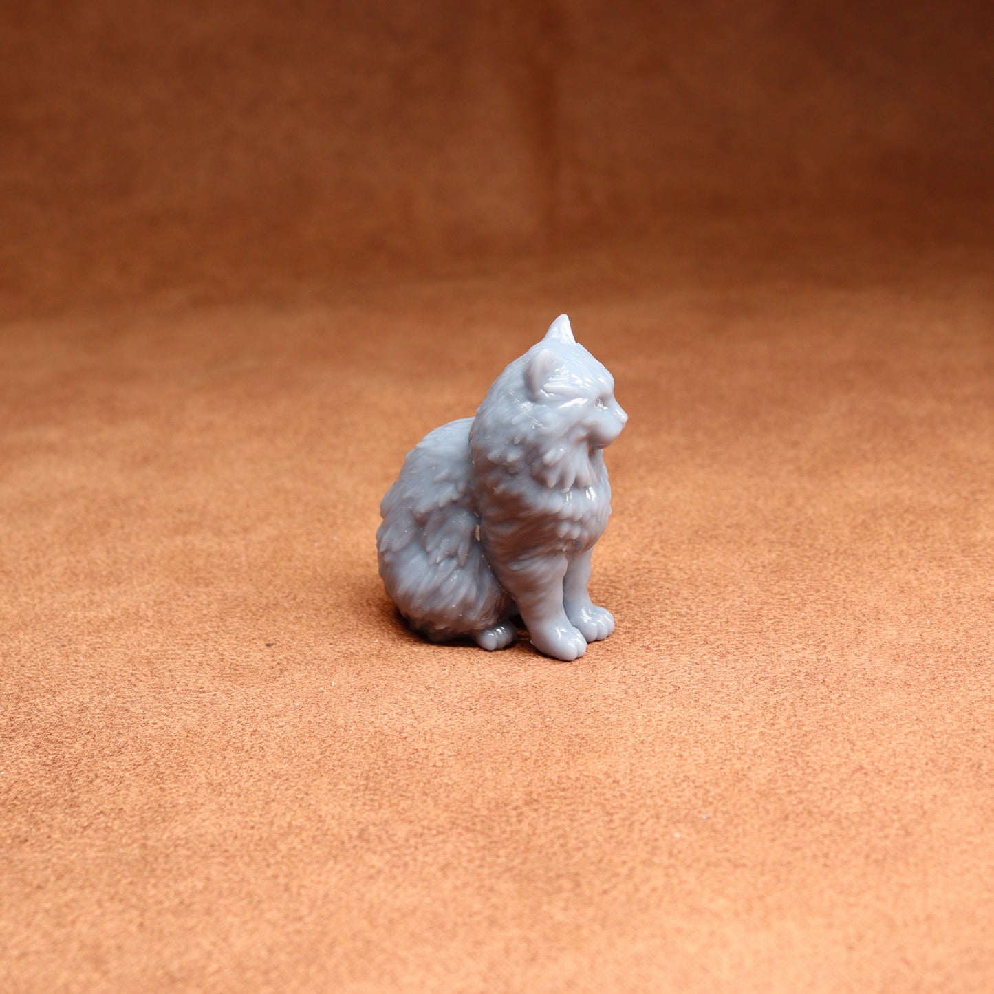 White cat figurine on a brown surface