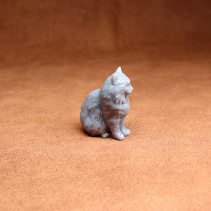 White cat figurine on a brown surface