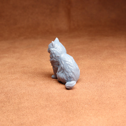 Gray cat figurine on a brown surface