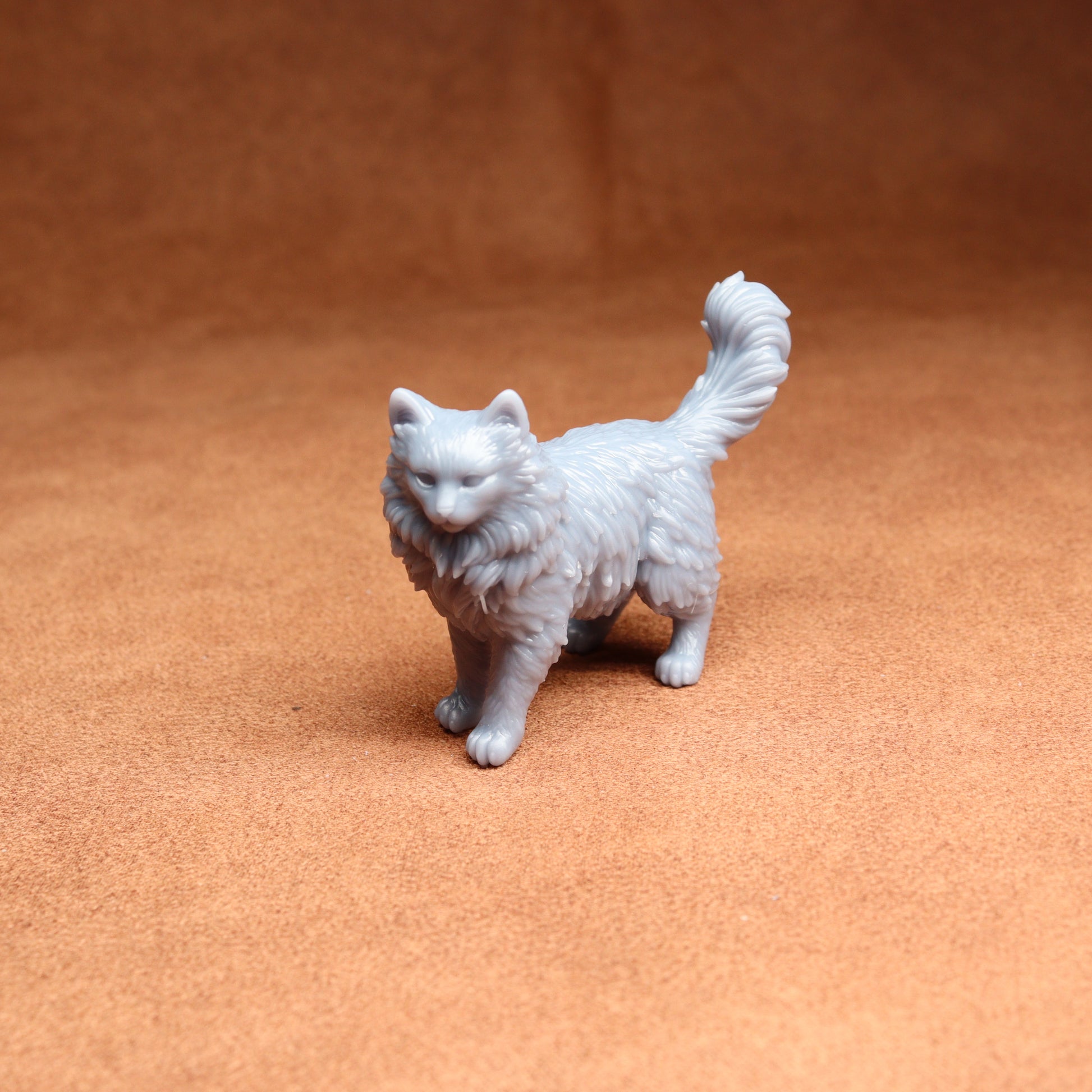 White cat figurine on a brown surface