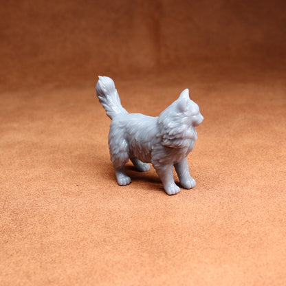 Gray cat figurine on a brown surface