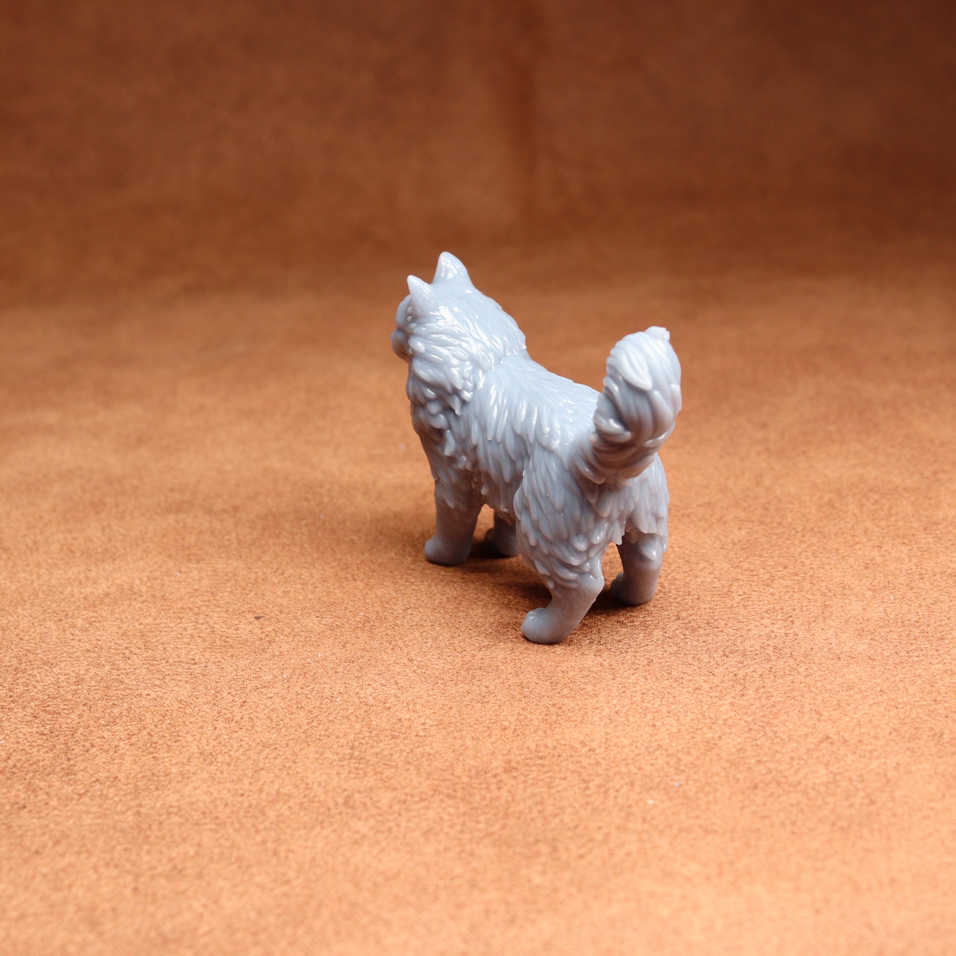 Gray dog figurine on a brown surface