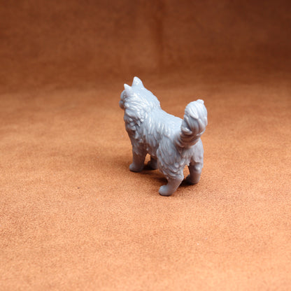 Gray dog figurine on a brown surface