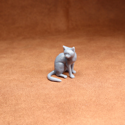 Gray cat figurine on a brown surface