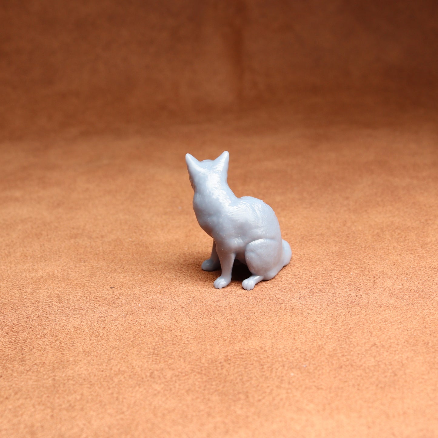 White dog figurine on a brown surface