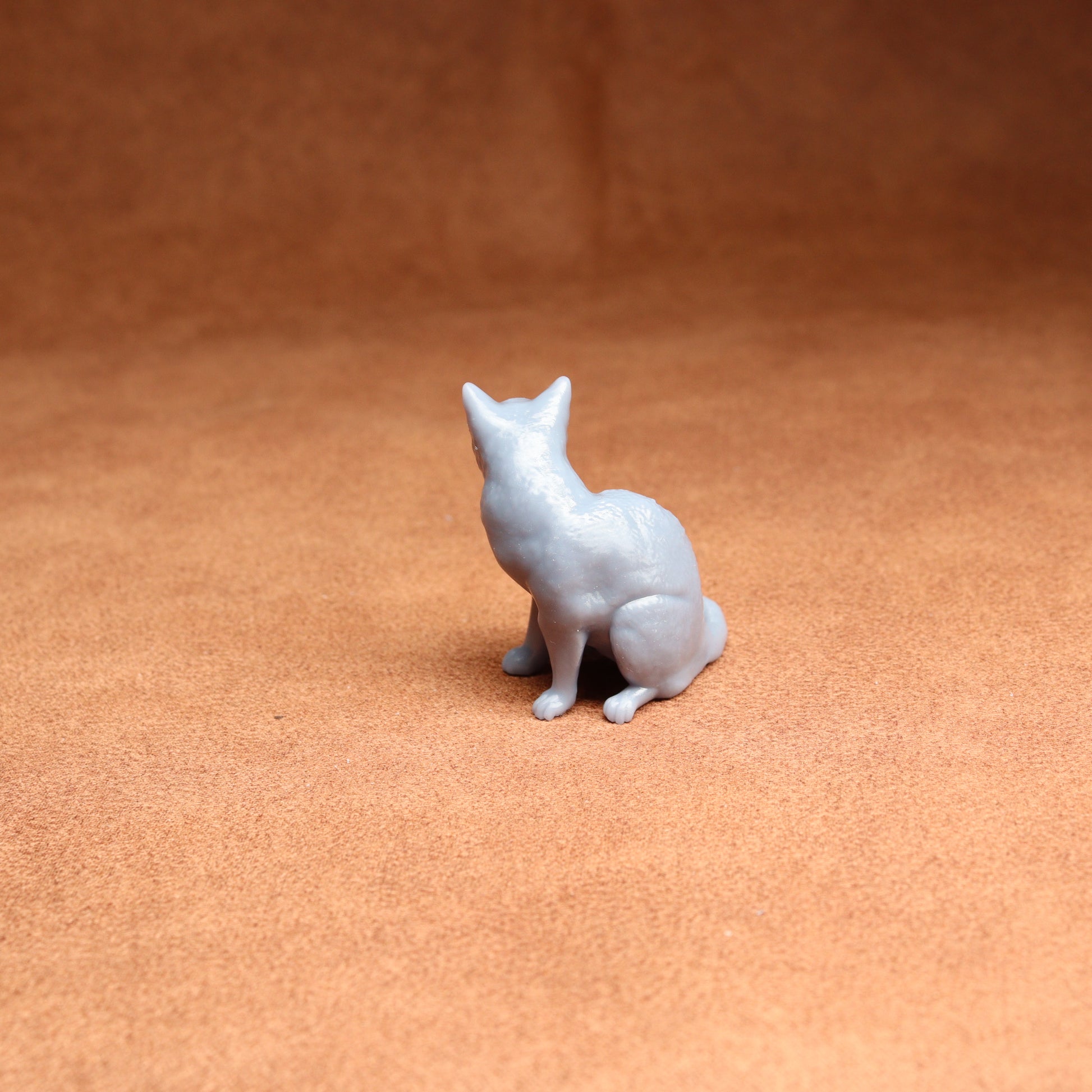 White dog figurine on a brown surface
