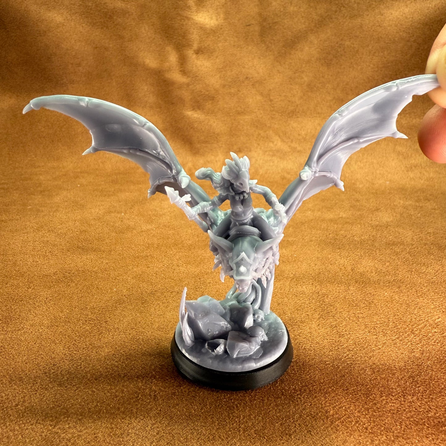 Fantasy figurine with wings on a brown textured background