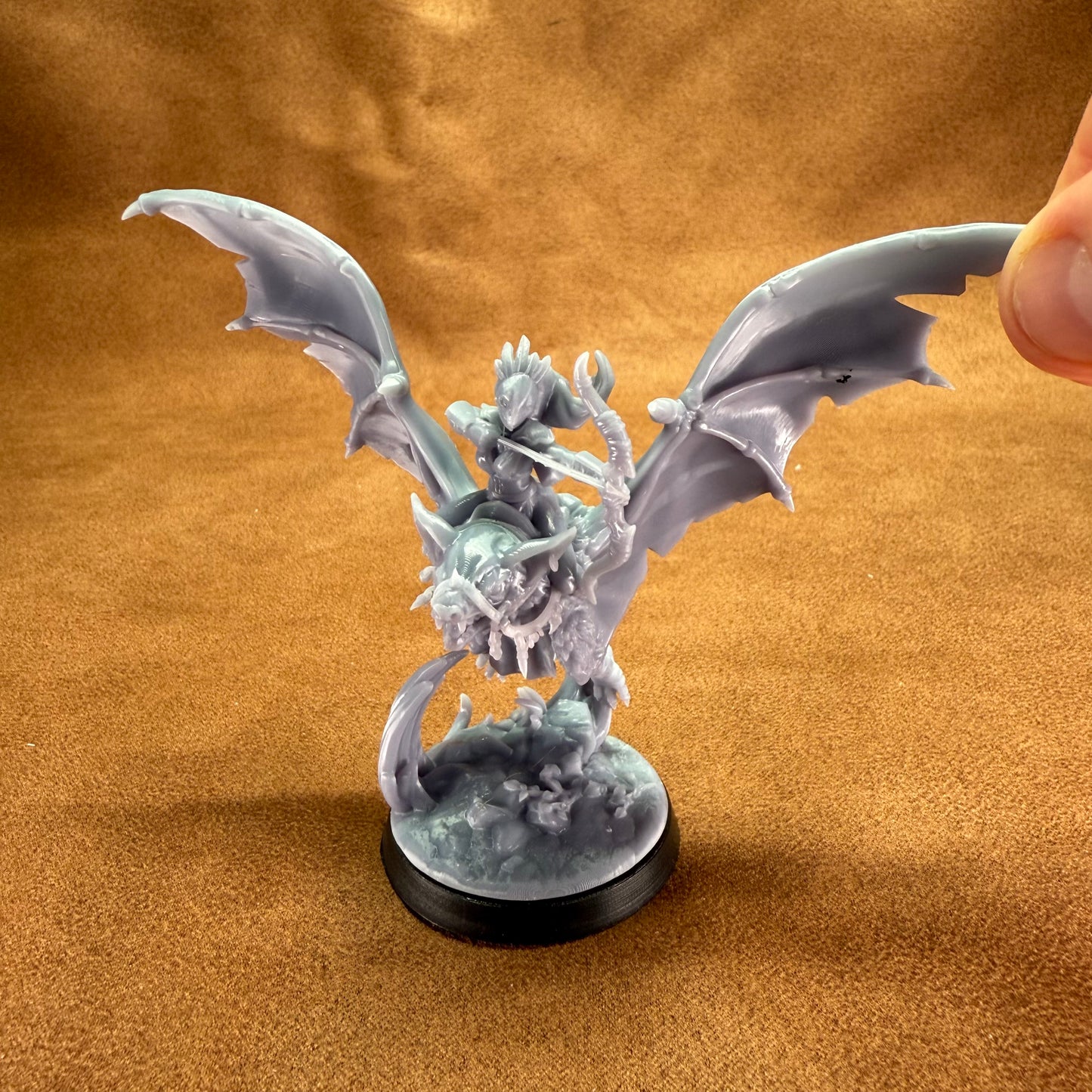 Dragon figurine on a brown textured background