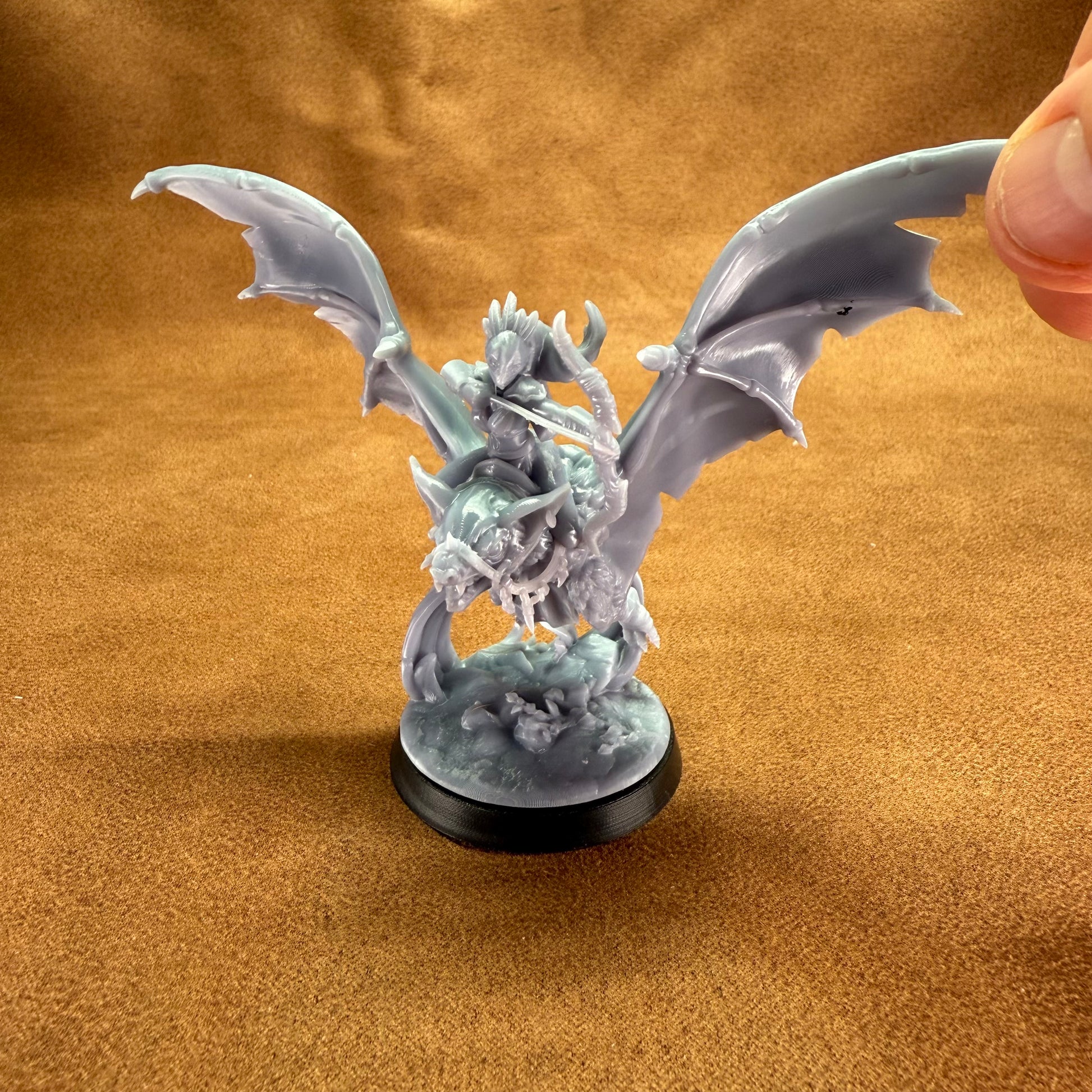 Fantasy dragon figurine on a brown background