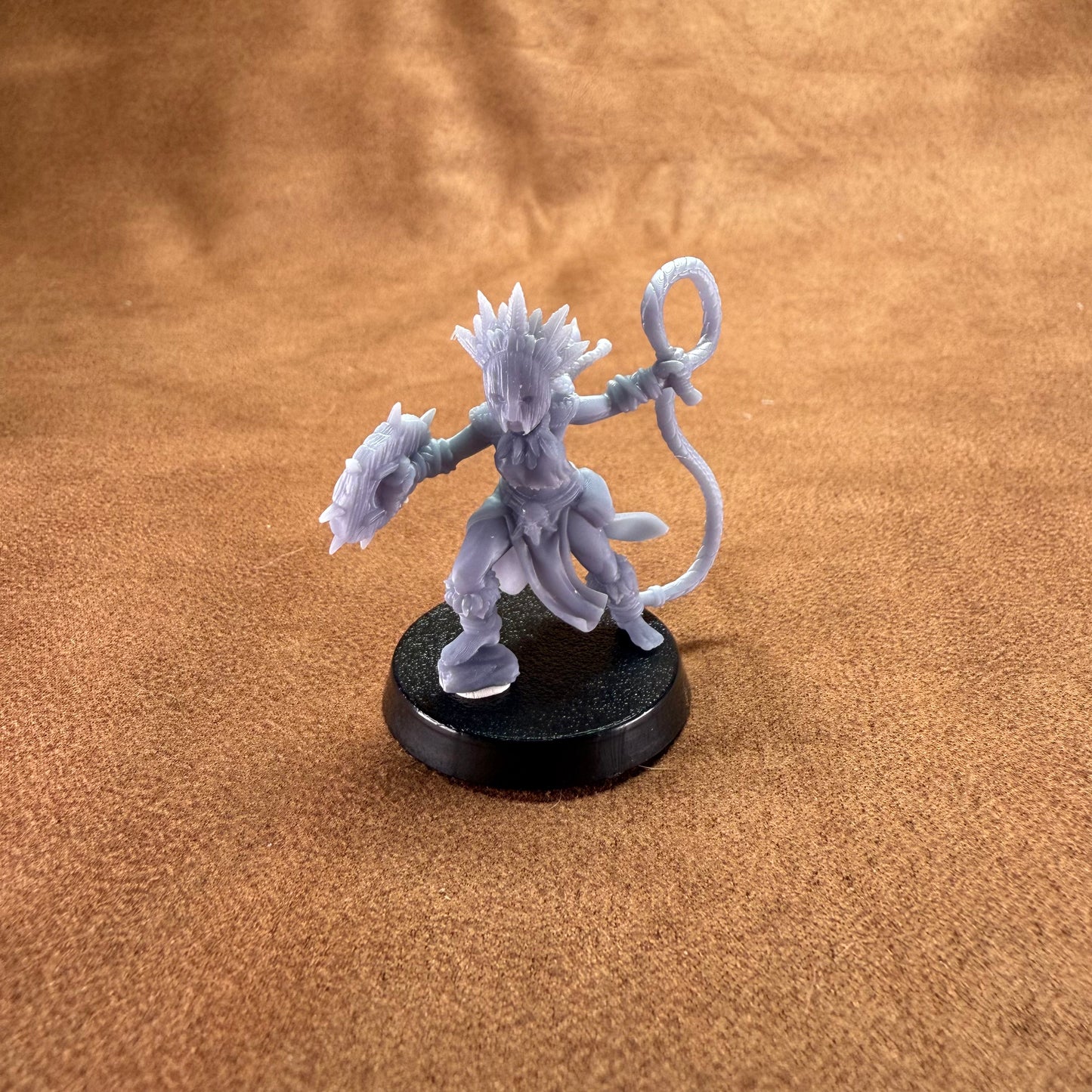 Gray fantasy figurine on a brown surface