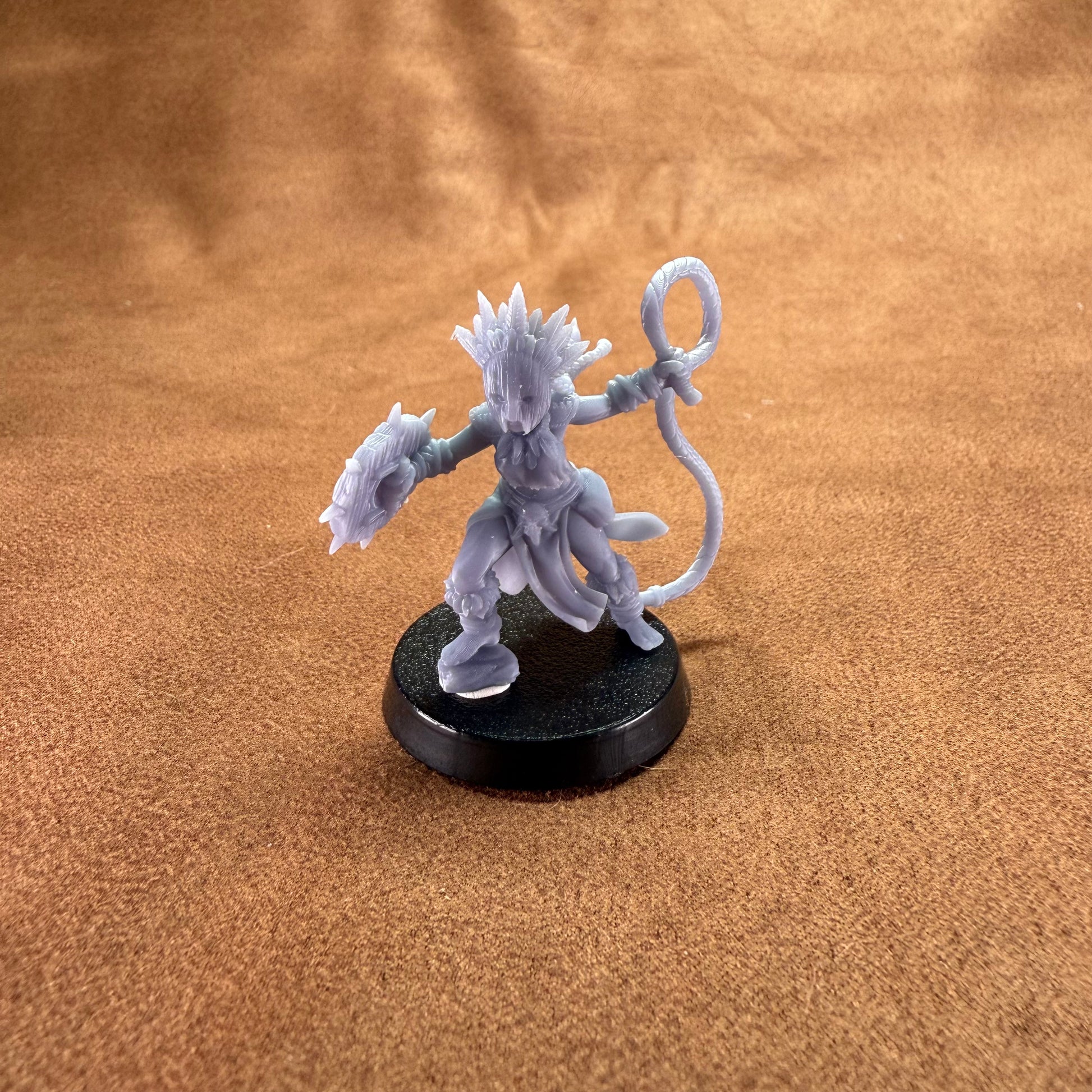 Gray fantasy figurine on a brown surface
