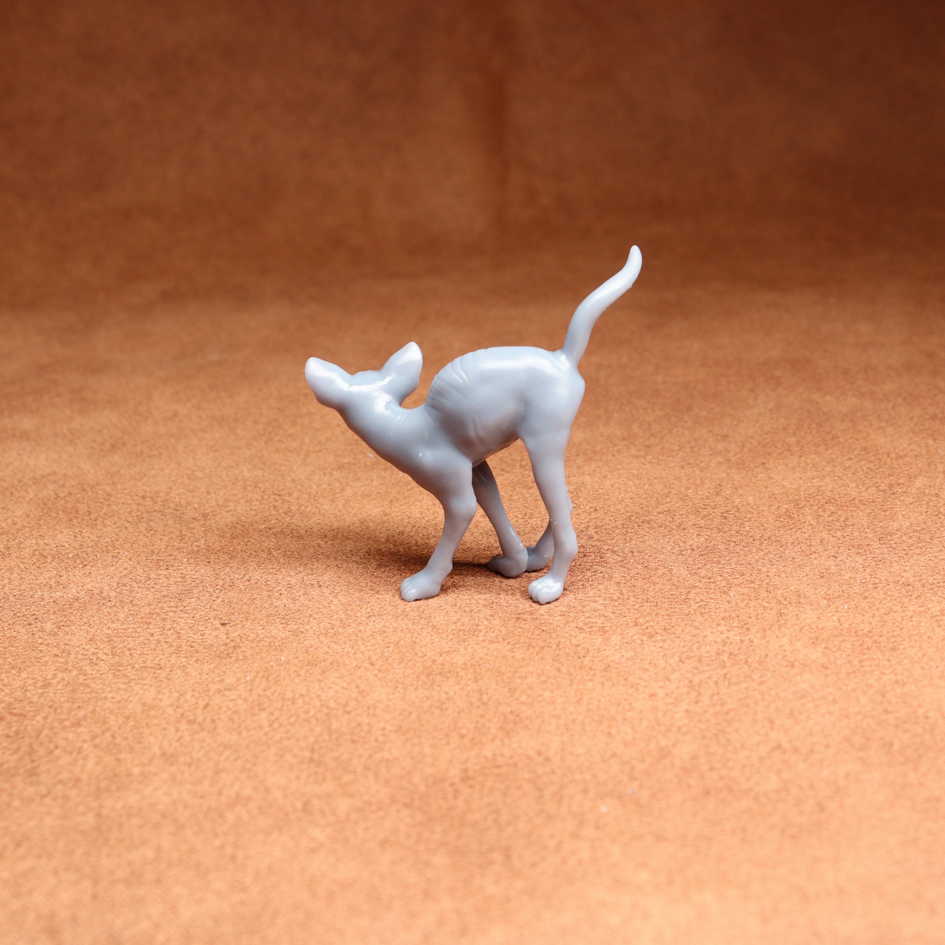 White dog figurine on a brown textured surface