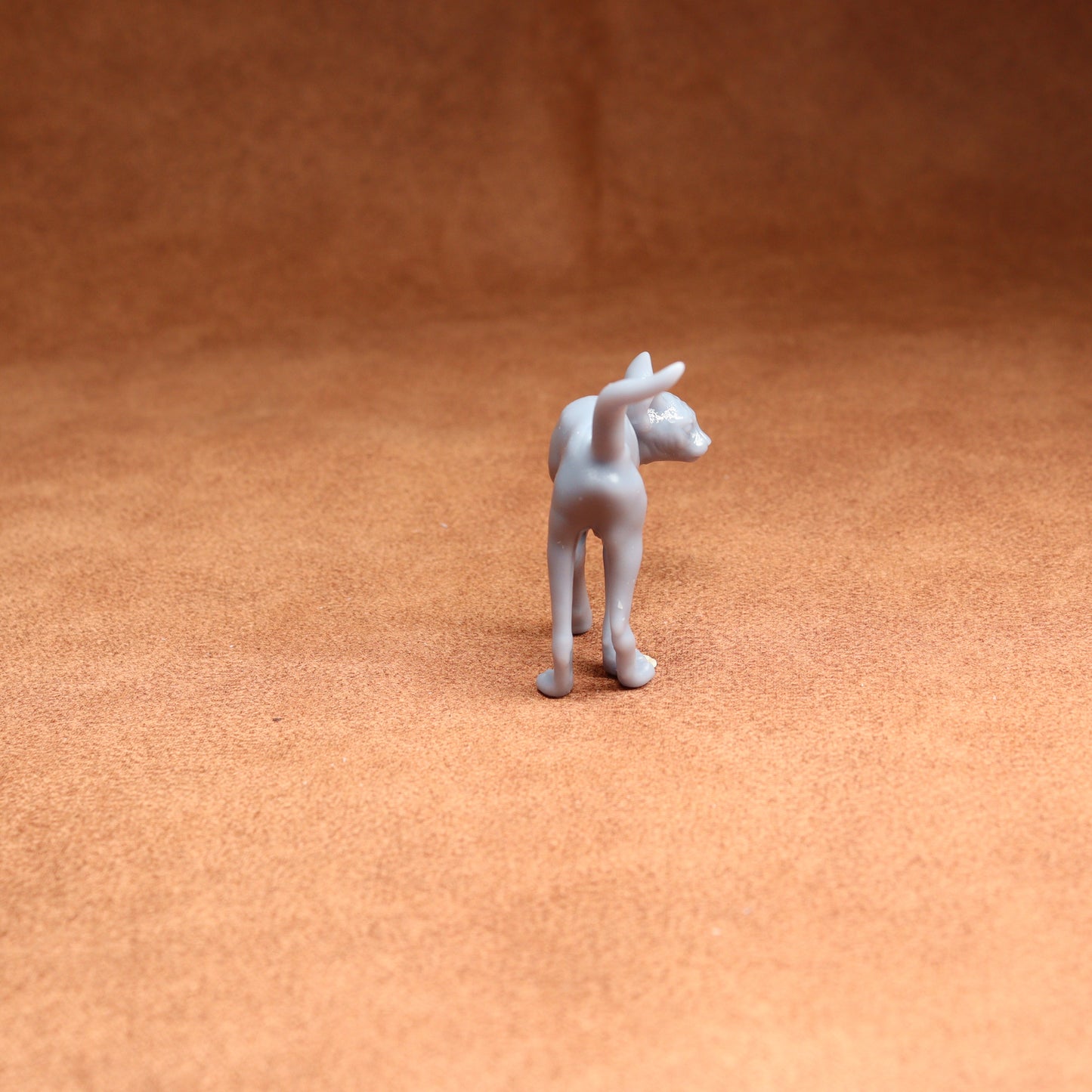 White dog figurine on a brown surface
