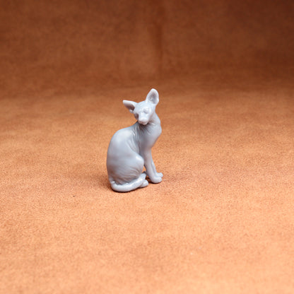 White cat figurine on a brown surface