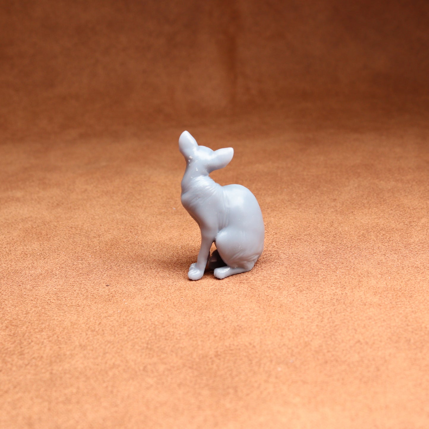 White ceramic deer figurine on a brown surface