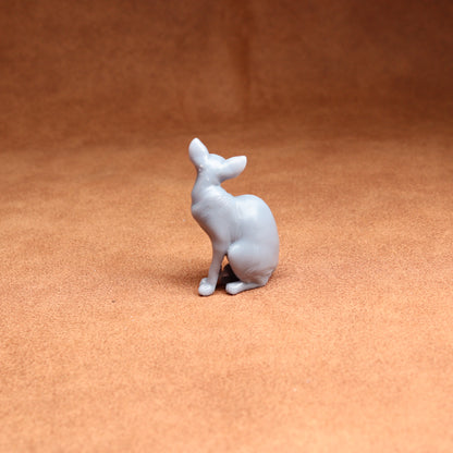 White ceramic deer figurine on a brown surface