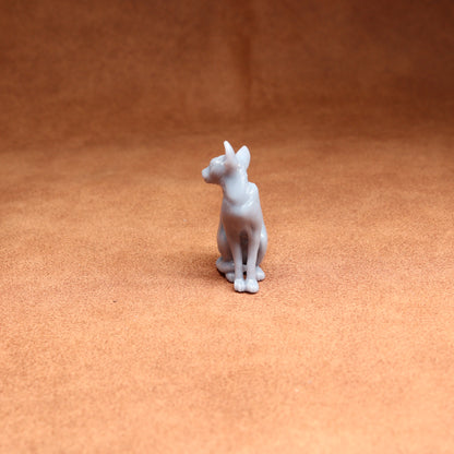 White dog figurine on a brown surface