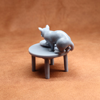 Gray cat figurine on a small round table against a brown background