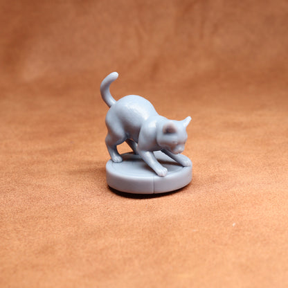 Gray cat figurine on a brown surface