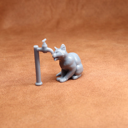 Small figurine of a cat interacting with a tap on a brown surface