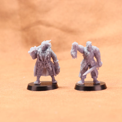 Two miniature figurines on a textured orange surface