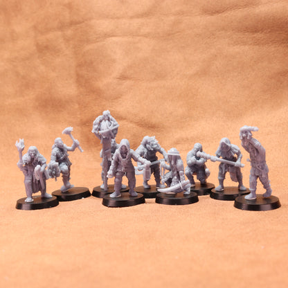 Set of gray miniature figures on black bases against a brown leather background