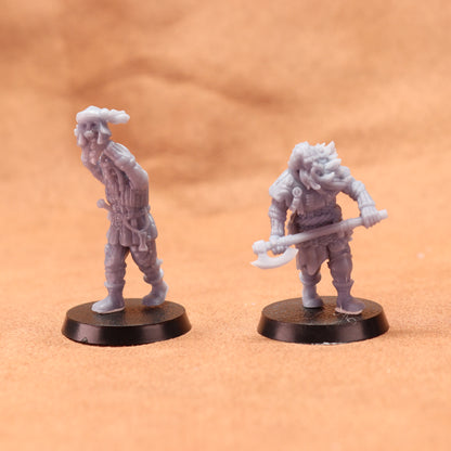 Two miniature figurines on a brown surface